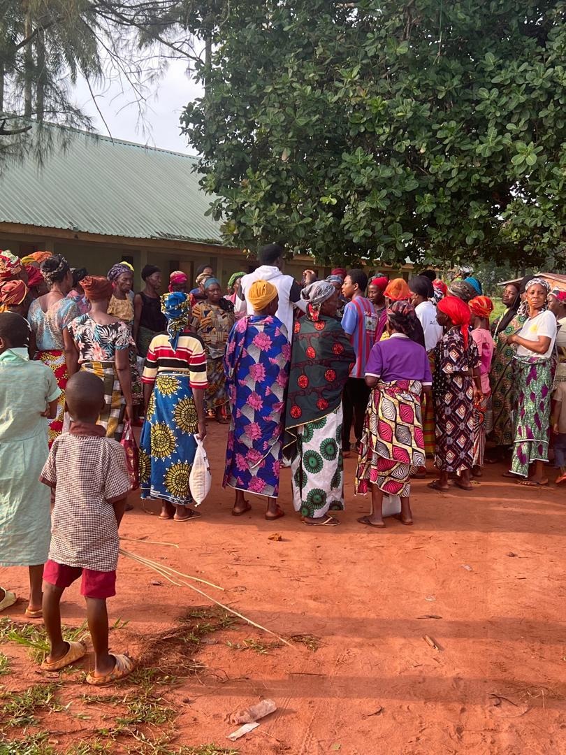 Women gathered in a community line during local outreach