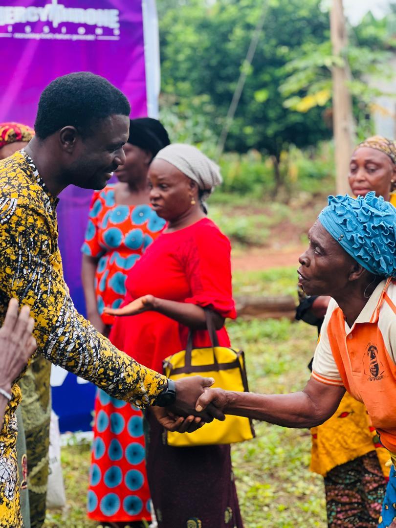 A local partner greeting a woman during outreach